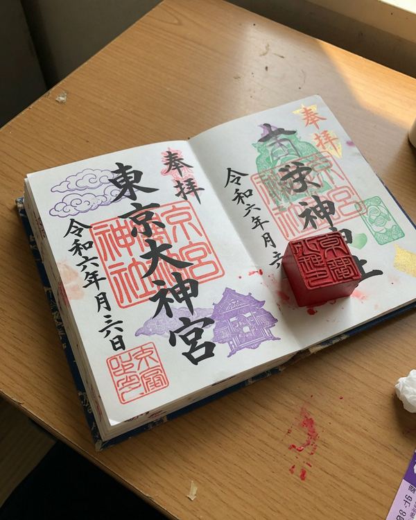 A goshuin stamp book open on its calligraphy